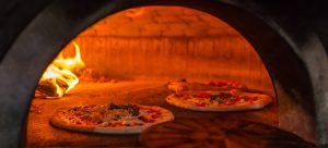 pizzaugn panorama 300x136 - Original neapolitan pizza margherita in a traditional wood oven in Naples restaurant, Italy